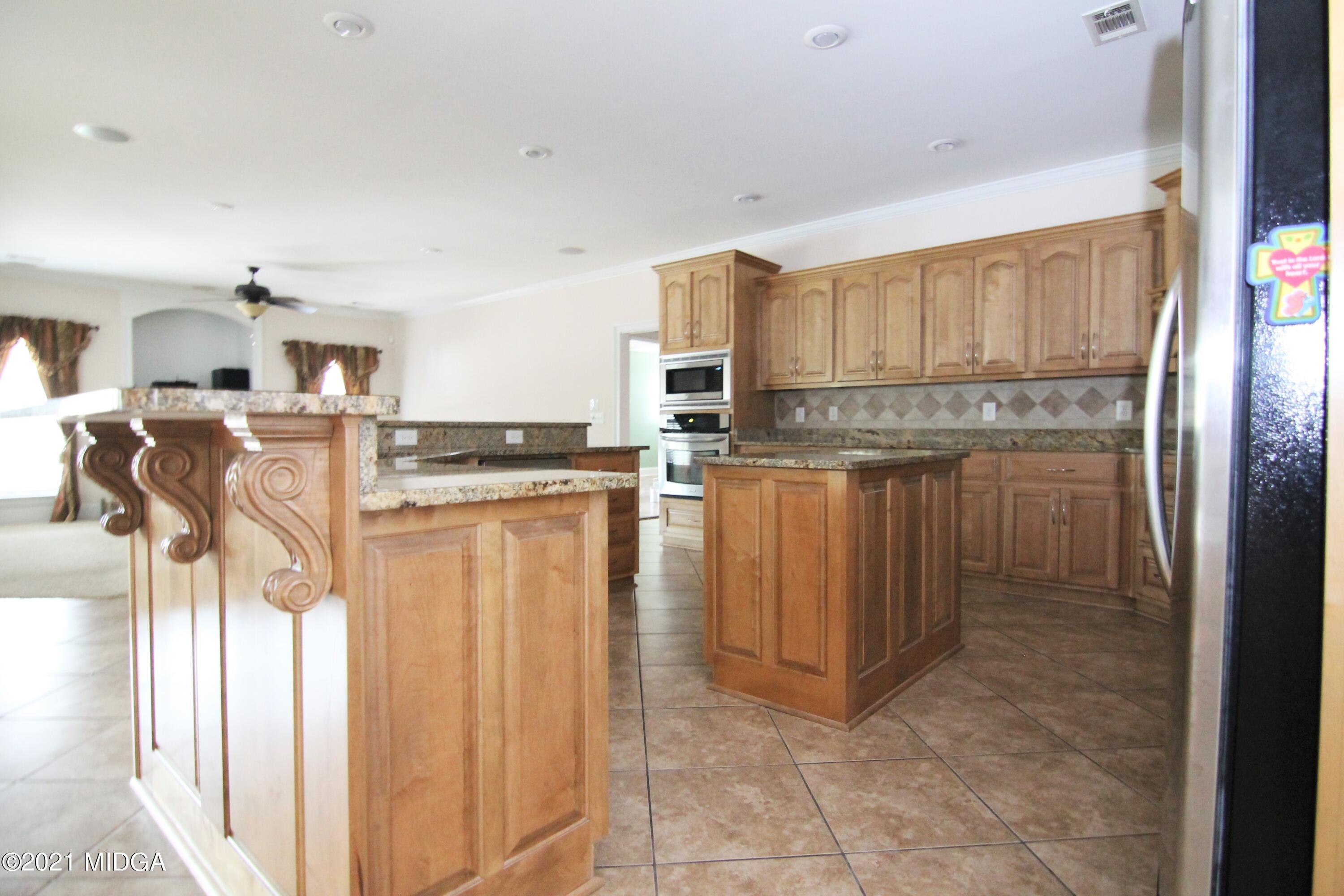 629 Toomer Road Perry, GA 31069 - Photo 10 of 59 a kitchen with stainless steel appliances granite countertop a refrigerator and a stove top oven