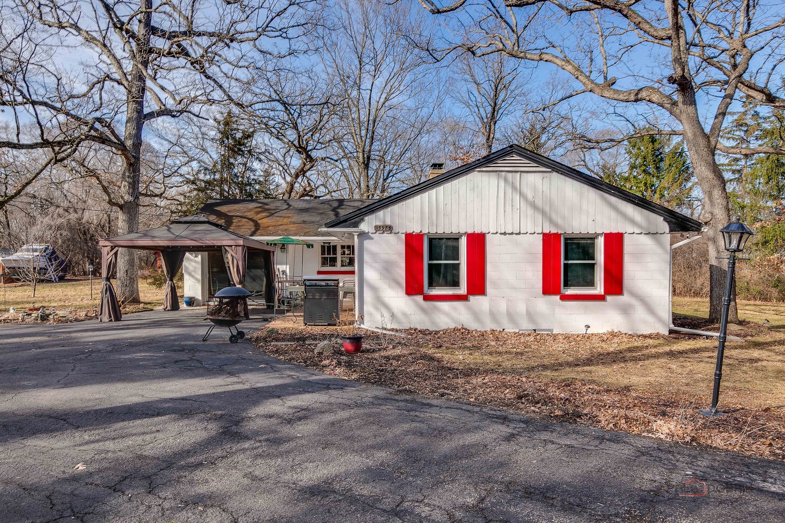 15983 West Wadsworth Road Wadsworth, IL 60083 - Photo 22 of 33 a view of a white house with a small yard and large tree