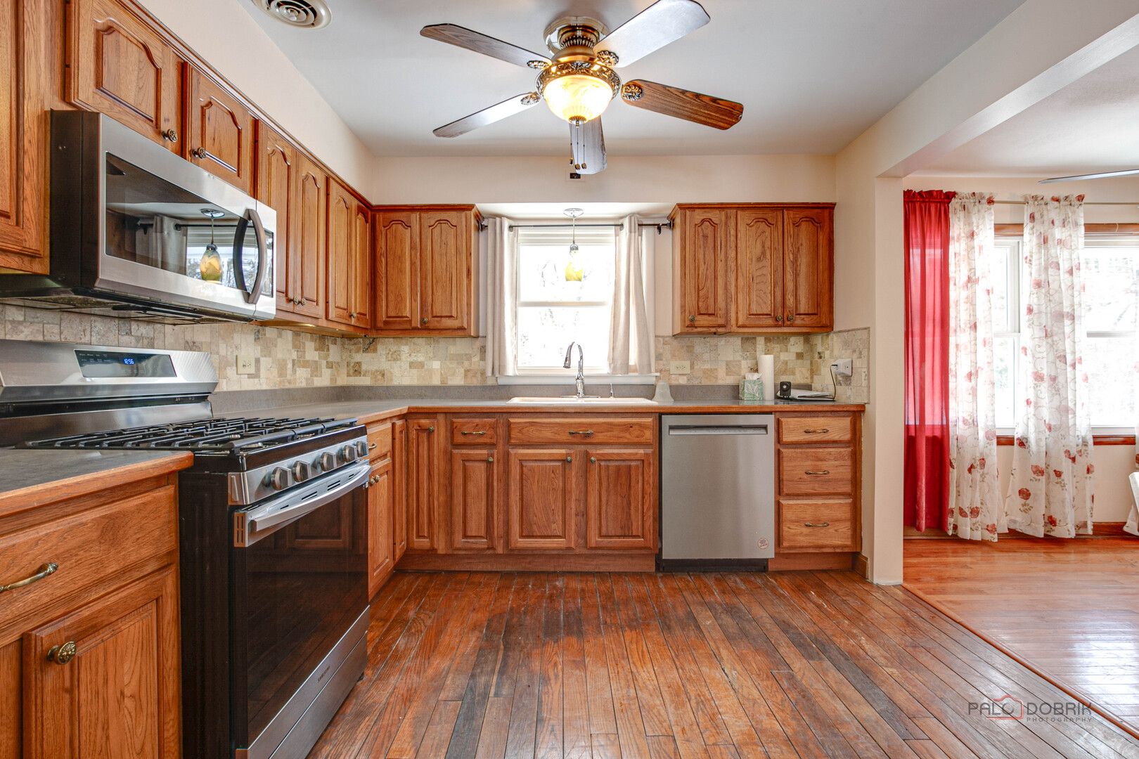 15983 West Wadsworth Road Wadsworth, IL 60083 - Photo 6 of 33 a kitchen with a stove a sink and a microwave