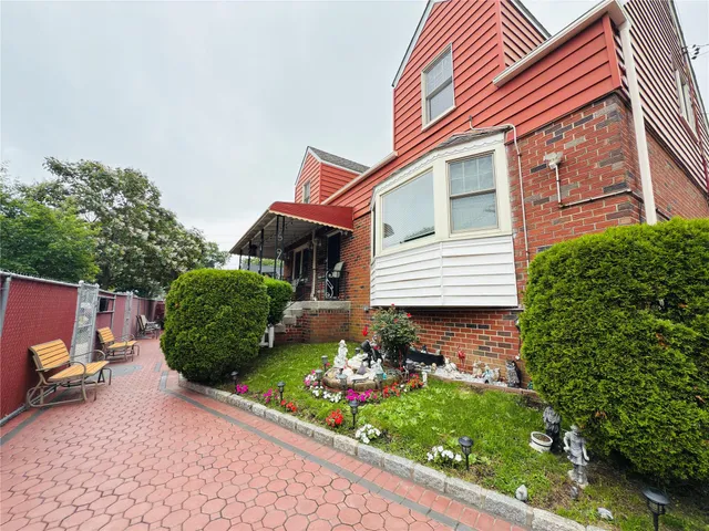a front view of a house with a yard and outdoor seating
