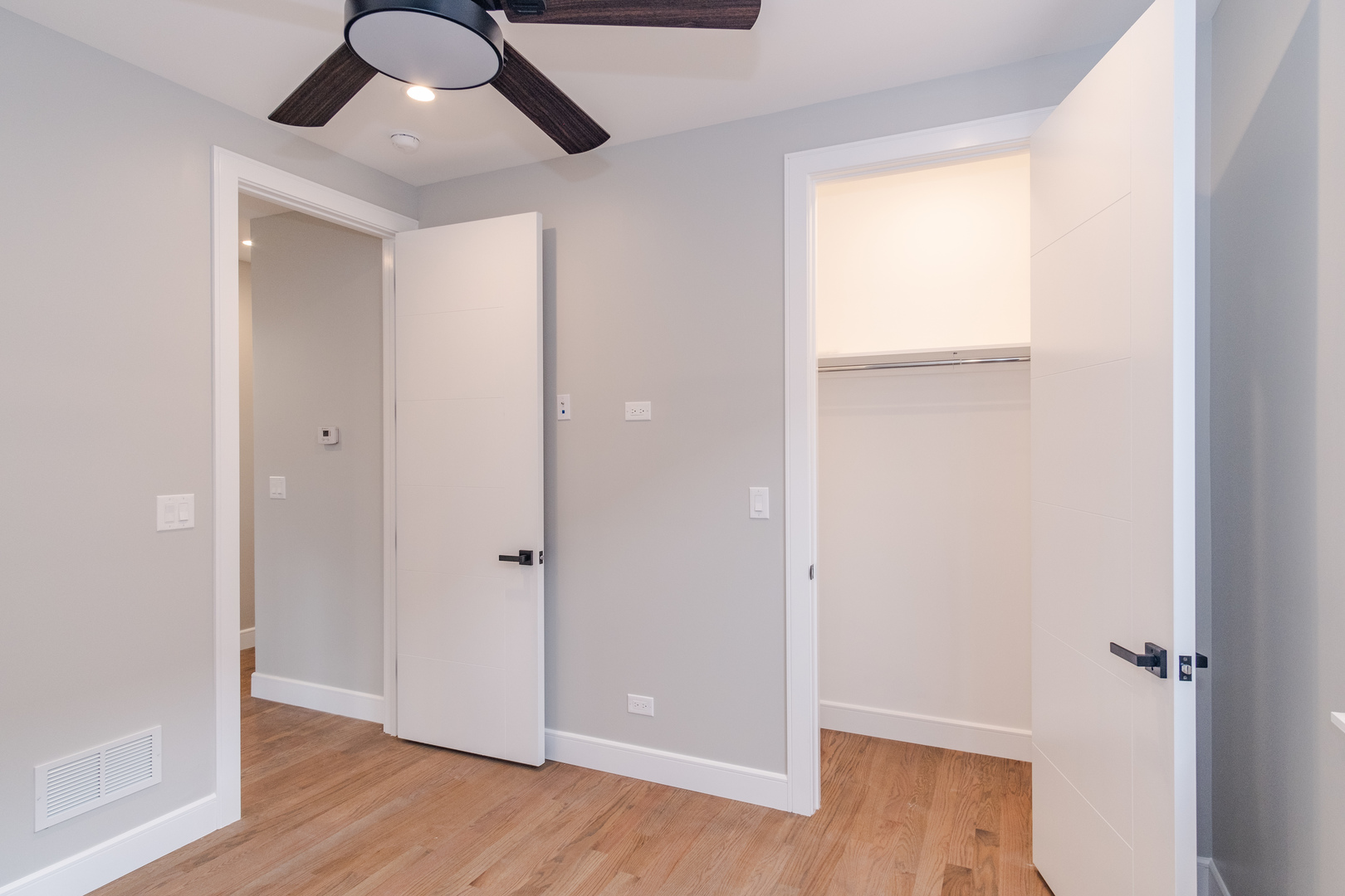 4639 South Indiana Avenue Chicago, IL 60615 - Photo 11 of 24 an empty room with wooden floor and windows