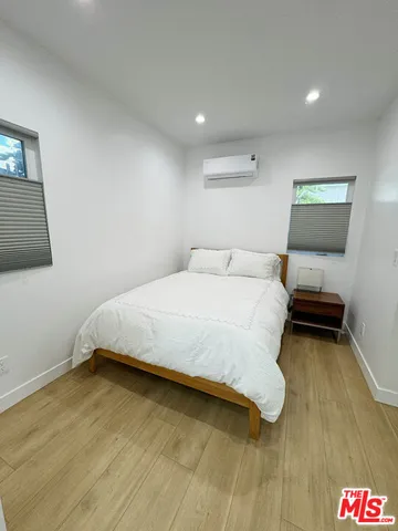 a bedroom with a bed and a night stand