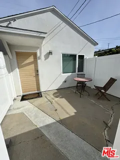 a backyard of a house with outdoor seating