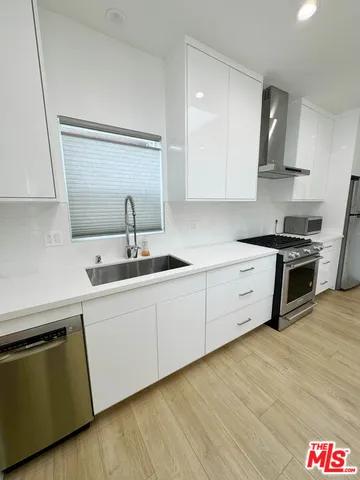 a kitchen with stainless steel appliances granite countertop a sink and cabinets