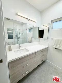 a bathroom with a double vanity sink and mirror