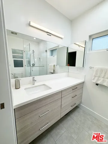 a bathroom with a double vanity sink and mirror