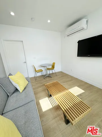 a living room with couch and a flat screen tv