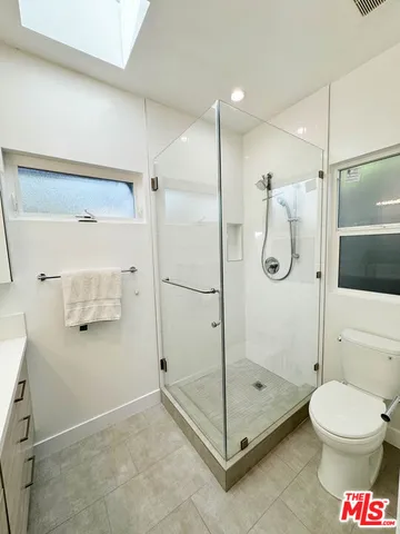 a bathroom with a shower a toilet and a shower