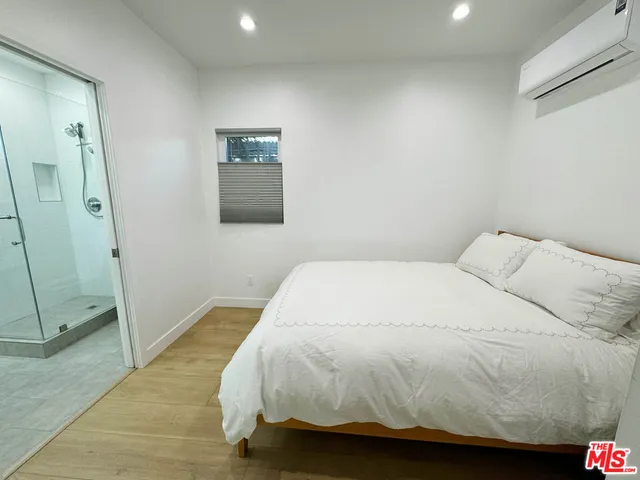 a bedroom with a bed and a shower
