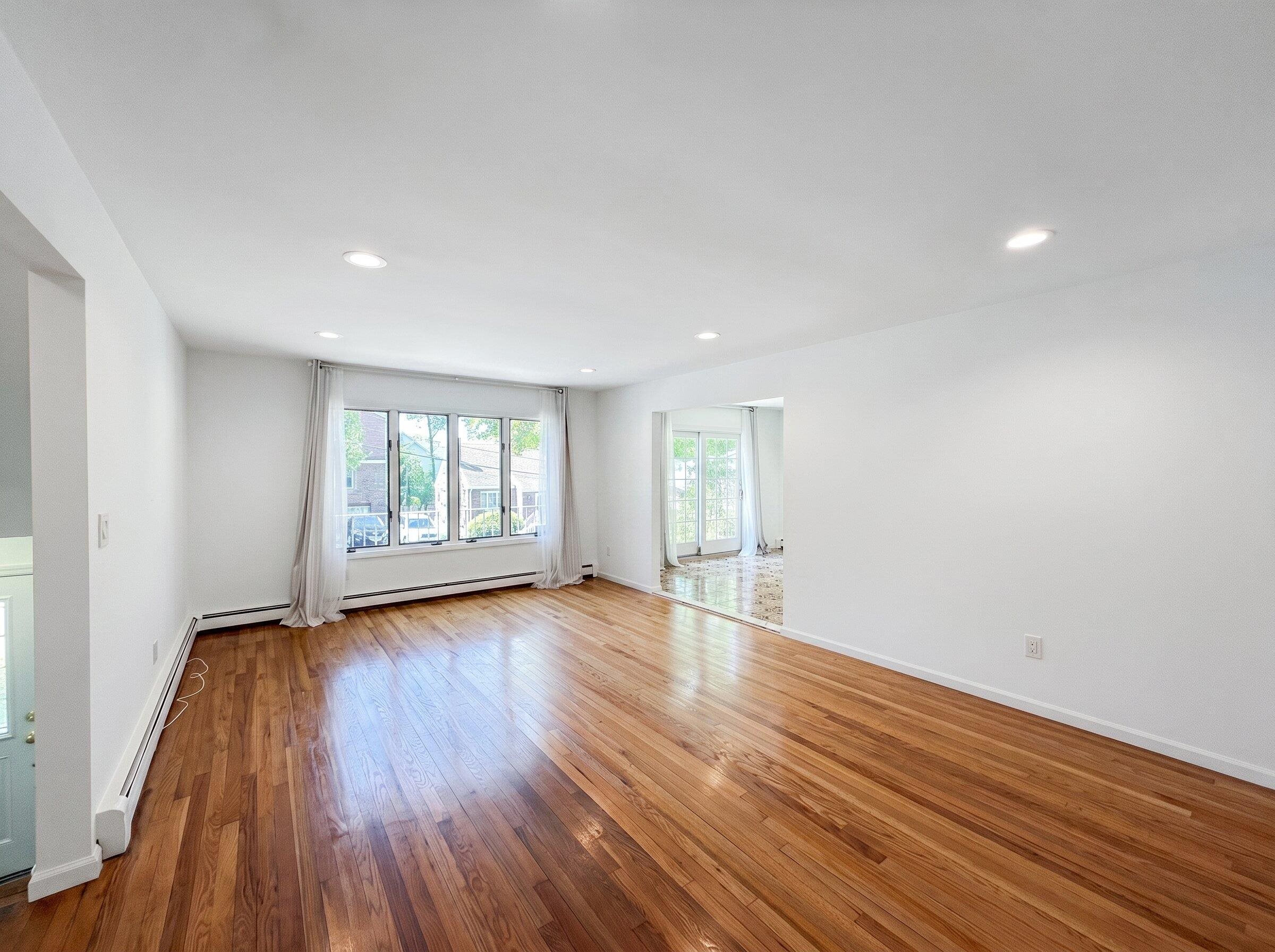531 Day Avenue, Unit 1 Ridgefield, NJ 07657 - Photo 11 of 32 a view of an empty room with wooden floor and a window