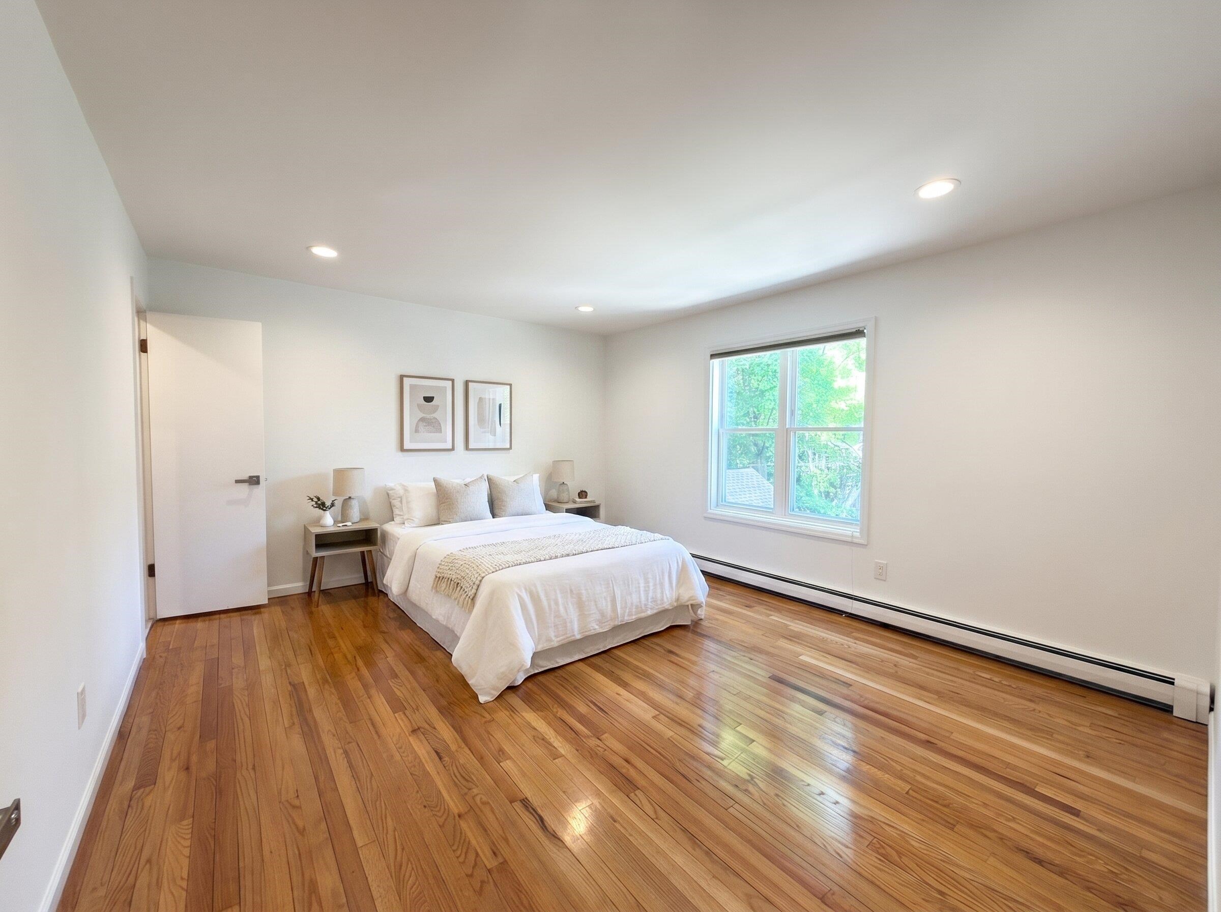 531 Day Avenue, Unit 1 Ridgefield, NJ 07657 - Photo 8 of 32 a spacious bedroom with a bed and a window