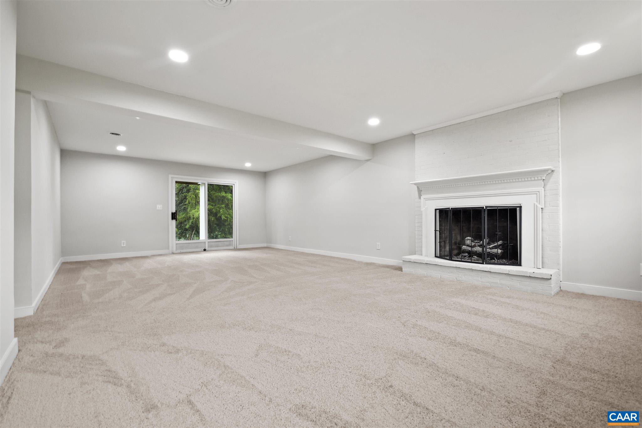 2614 Huntington Road Charlottesville, VA 22901 - Photo 17 of 29 an empty room with a fireplace and a window