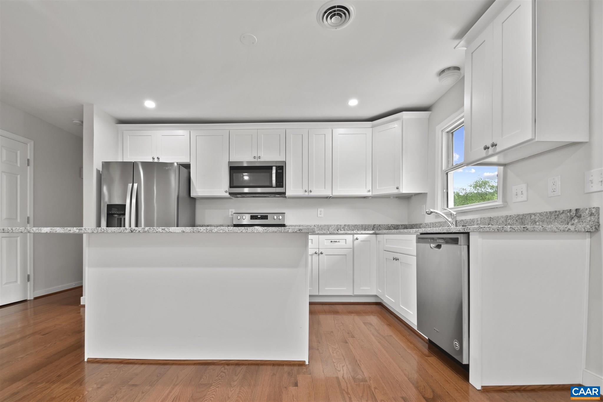 2614 Huntington Road Charlottesville, VA 22901 - Photo 5 of 29 a kitchen with stainless steel appliances granite countertop a refrigerator a stove top oven a sink and dishwasher with wooden floor