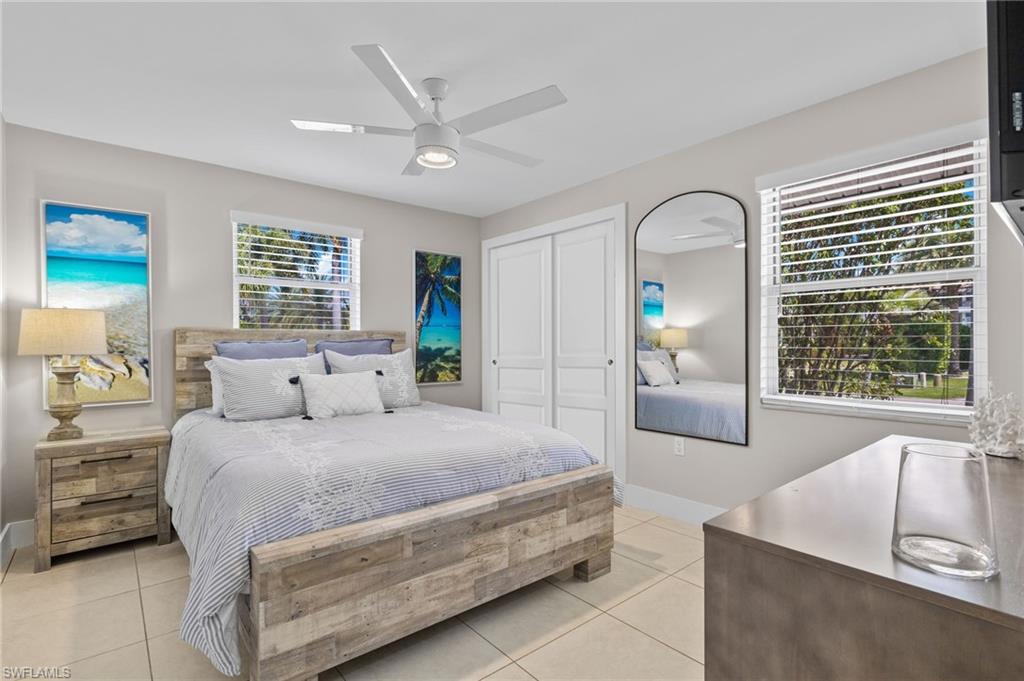482 Trade Winds Avenue Naples, FL 34108 - Photo 17 of 26 a bedroom with a large bed and a large window