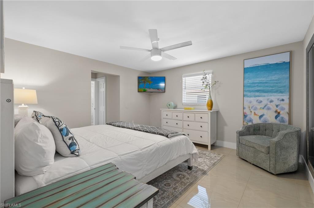 482 Trade Winds Avenue Naples, FL 34108 - Photo 19 of 26 a bedroom with a bed and a couch