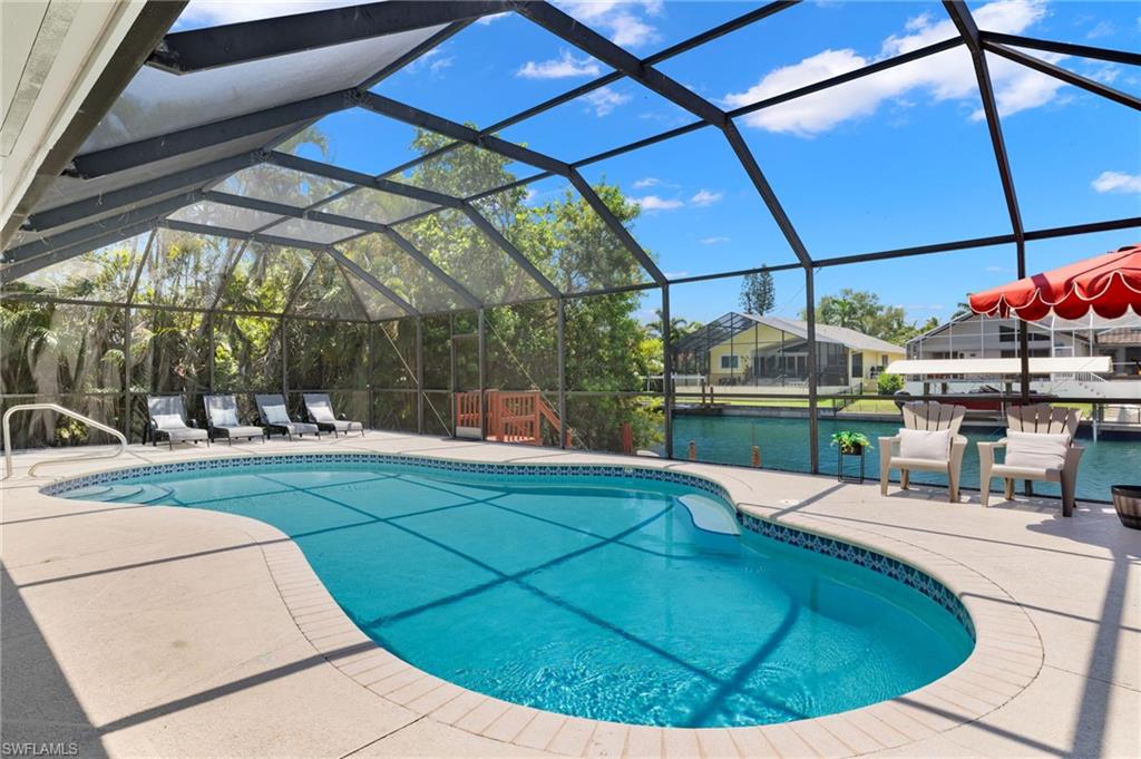 482 Trade Winds Avenue Naples, FL 34108 - Photo 25 of 26 a view of a swimming pool with a sitting area
