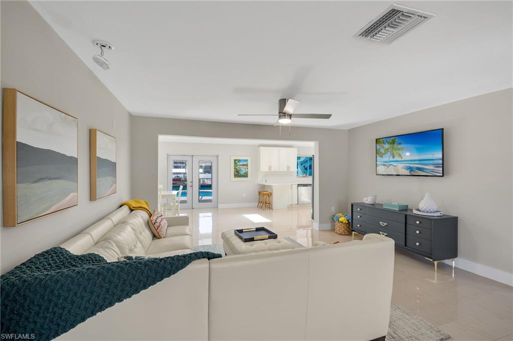 482 Trade Winds Avenue Naples, FL 34108 - Photo 5 of 26 a living room with furniture and a flat screen tv