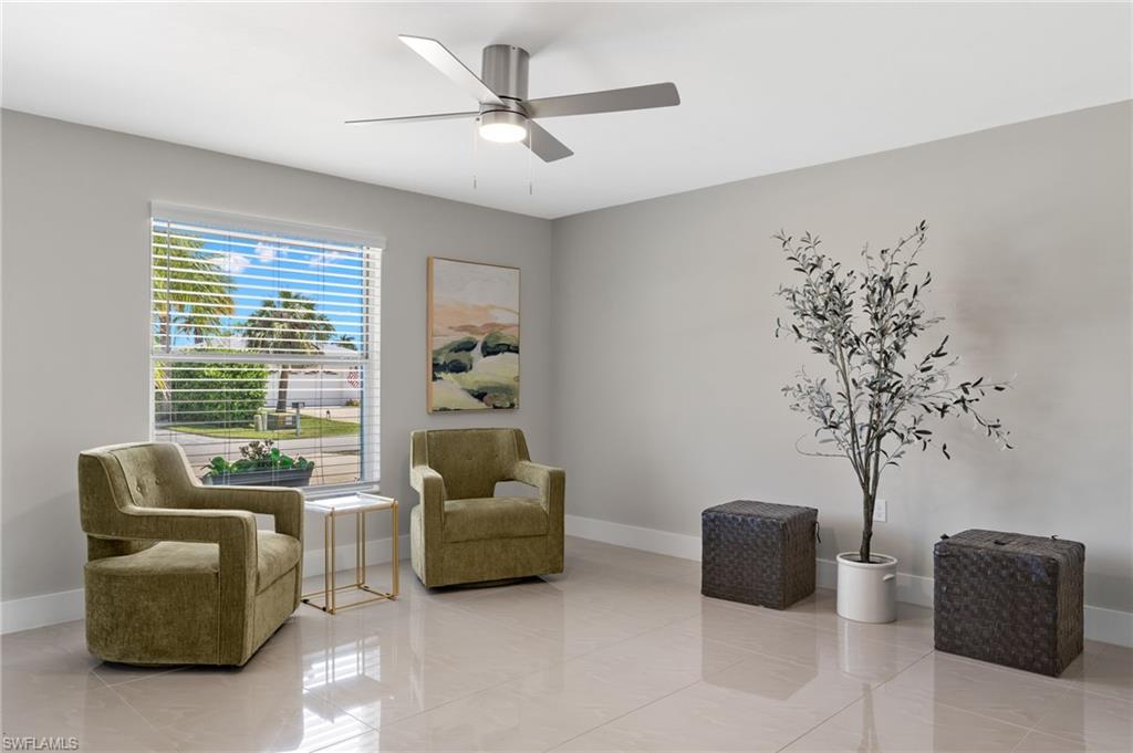 482 Trade Winds Avenue Naples, FL 34108 - Photo 6 of 26 a living room with furniture and a large window