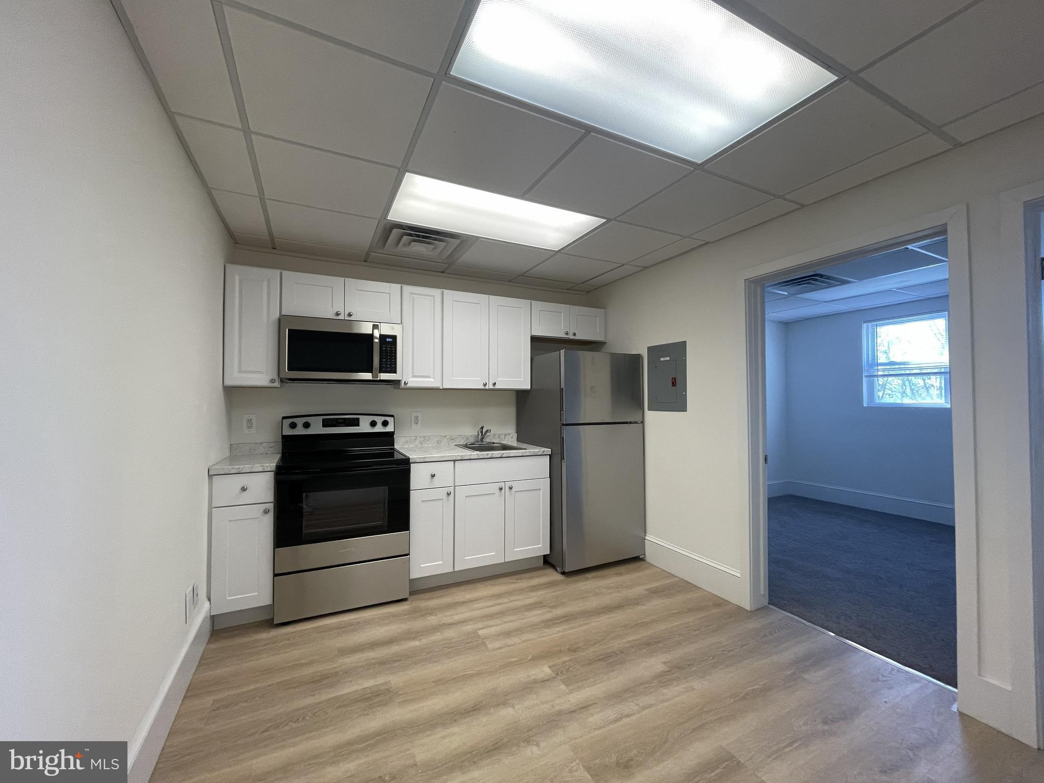 a kitchen with stainless steel appliances a refrigerator stove and microwave