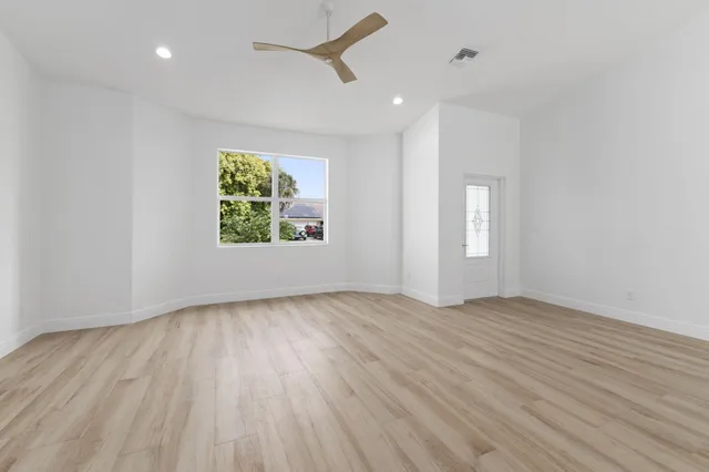 wooden floor in an empty room with a window