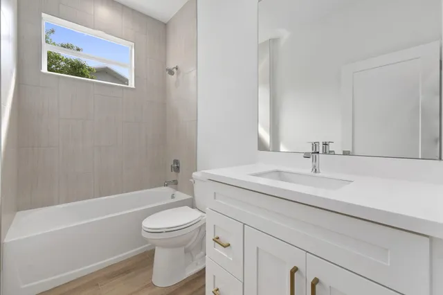 a bathroom with a sink a toilet and a bathtub