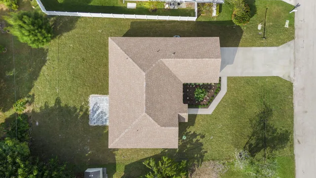 an aerial view of a house with a yard