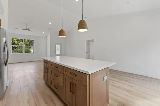 a kitchen with a wooden floor and window