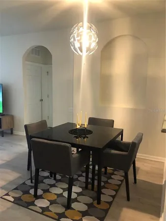 a view of a dining room with furniture and wooden floor