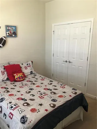 a bedroom with a bed and a dresser