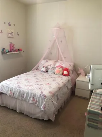 a bedroom with a bed and a couch