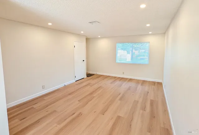 a view of room with wooden floor and window