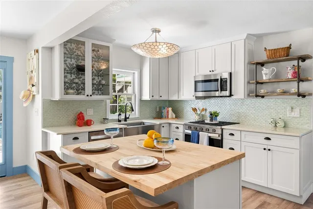 a living room with furniture a chandelier and a large window