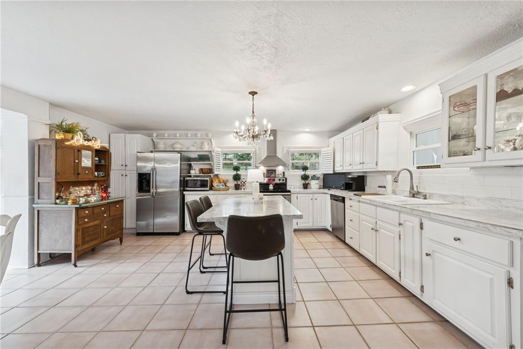 3024 Hyland Road Irwin, PA 15642 - Photo 18 of 45 a kitchen with stainless steel appliances kitchen island granite countertop a sink and cabinets