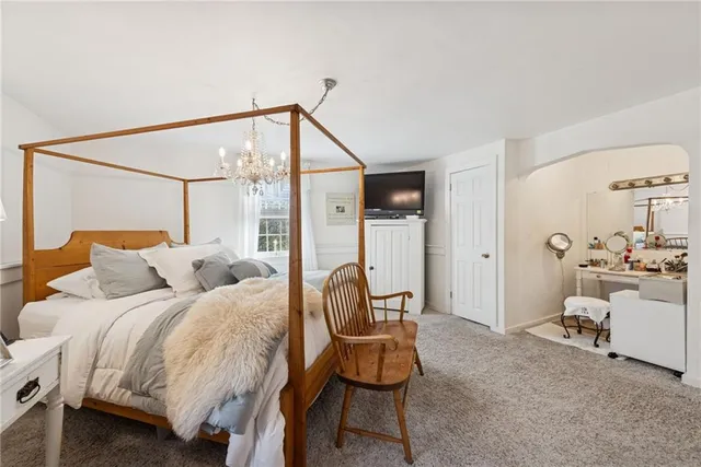 a bedroom with a bed window and couch