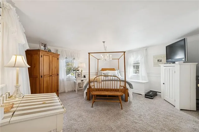 a bedroom with furniture and a flat screen tv