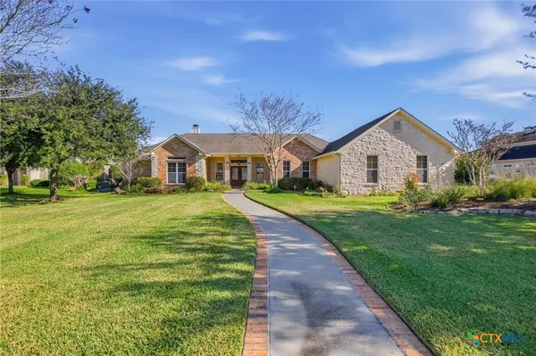 a front view of house with yard and green space
