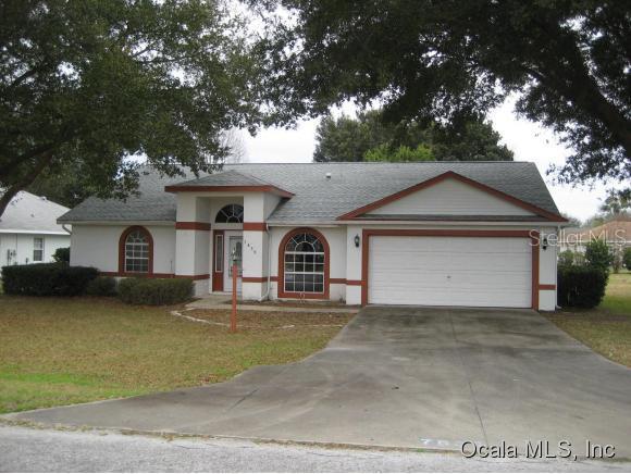 7839 Southwest 63rd Ave Road Ocala, FL 34476 - Photo 1 of 1 a front view of a house with a yard and garage