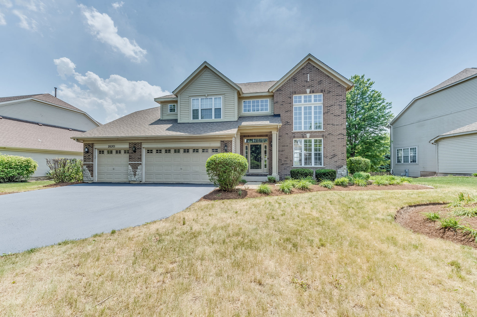26301 Mapleview Drive Plainfield, IL 60585 - Photo 1 of 1 a front view of a house with a yard and garage