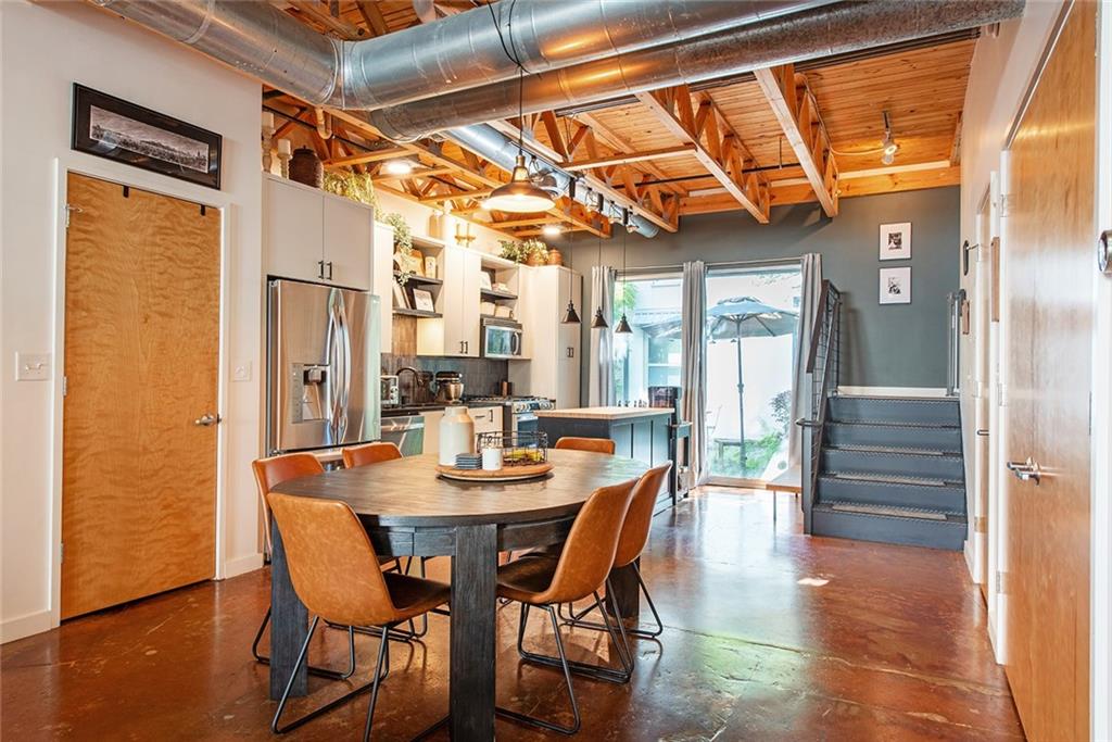 1661 La France Street Northeast, Unit 325 Atlanta, GA 30307 - Photo 14 of 40 a dining room with furniture a chandelier and wooden floor