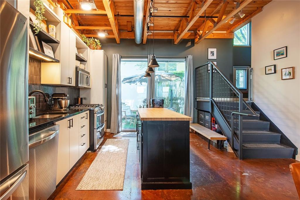1661 La France Street Northeast, Unit 325 Atlanta, GA 30307 - Photo 20 of 40 a kitchen with granite countertop a stove a sink and a refrigerator
