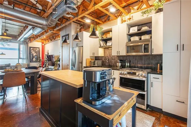 a kitchen with stainless steel appliances granite countertop a stove and a refrigerator