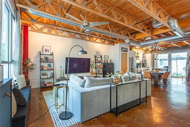 a living room with fireplace furniture and a large window