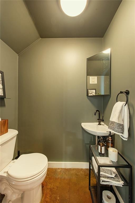 1661 La France Street Northeast, Unit 325 Atlanta, GA 30307 - Photo 23 of 40 a bathroom with a sink a toilet and a mirror