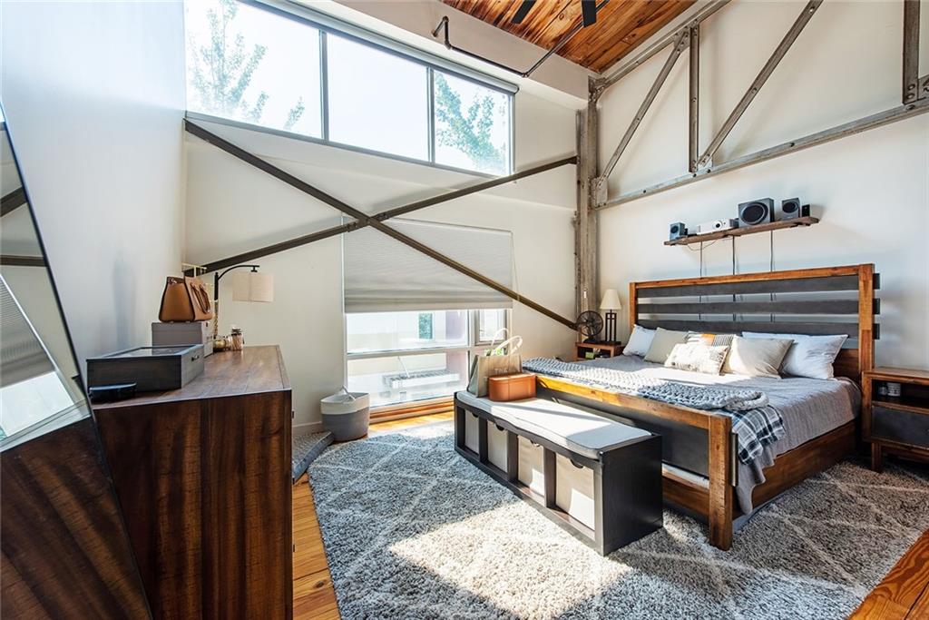 1661 La France Street Northeast, Unit 325 Atlanta, GA 30307 - Photo 25 of 40 a bedroom with bed and wooden floor