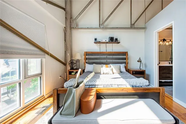 a bedroom with a bed and glass door