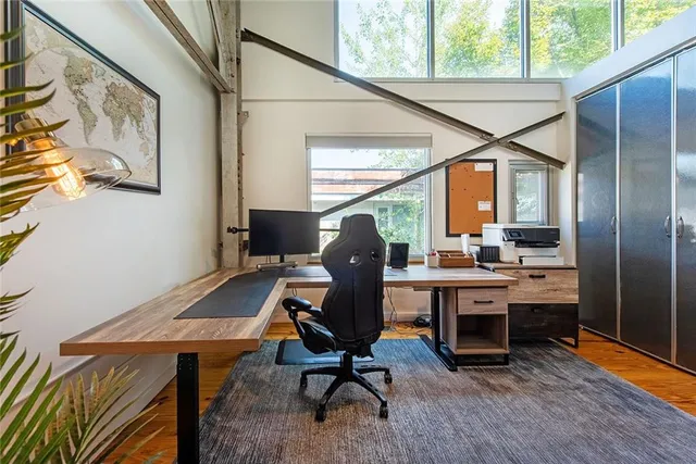 a view of a workspace with furniture and a window