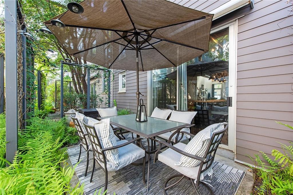 1661 La France Street Northeast, Unit 325 Atlanta, GA 30307 - Photo 37 of 40 a patio with a patio table and chairs