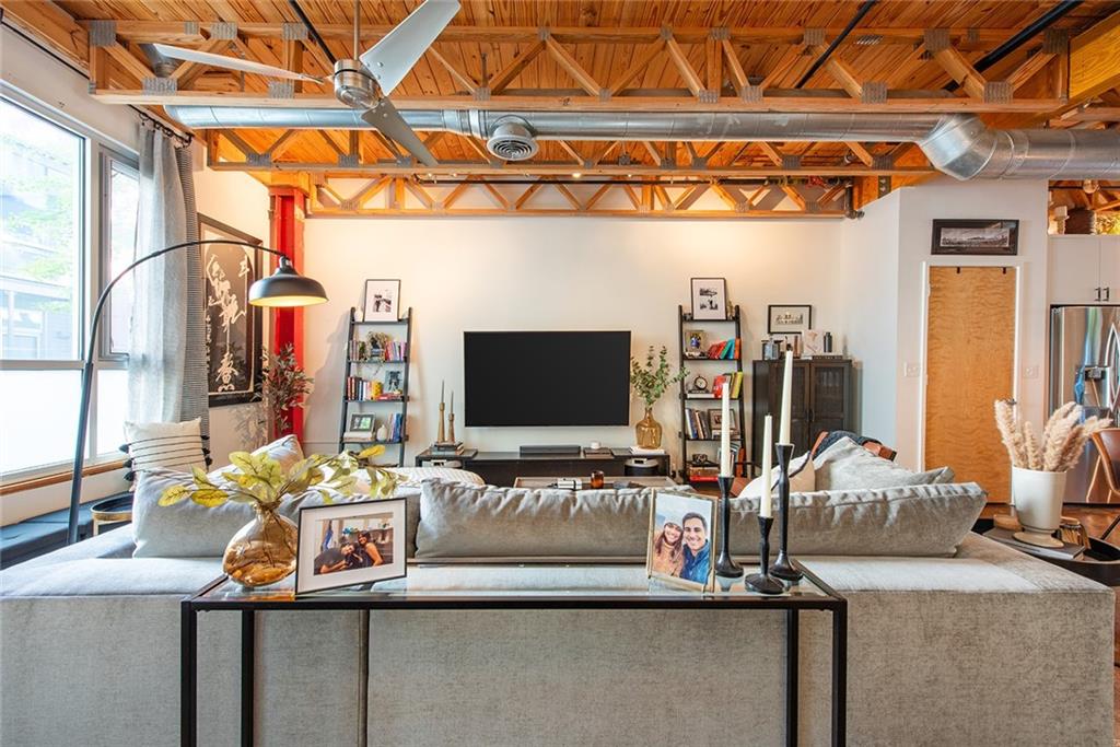 1661 La France Street Northeast, Unit 325 Atlanta, GA 30307 - Photo 8 of 40 a living room with furniture and a flat screen tv