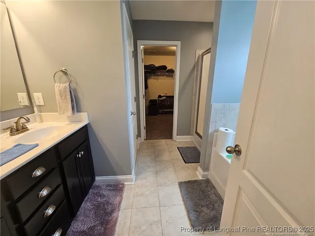 a bathroom with a double vanity sink and a mirror