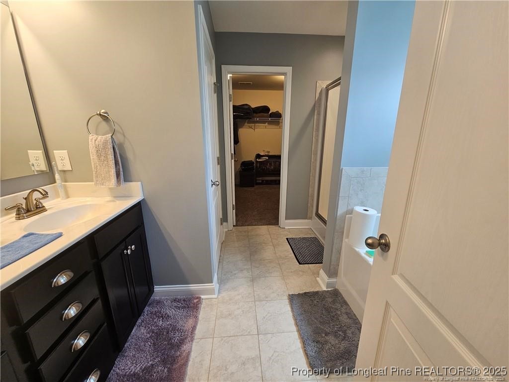 181 Pendleton Street Raeford, NC 28376 - Photo 12 of 19 a bathroom with a double vanity sink and a mirror